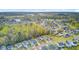 High angle aerial view showcasing houses near green trees and a lake in the distance at 236 Emerald Isle Dr, Moncks Corner, SC 29461