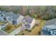 Aerial view of a tan two story home with manicured lawn, trees, and a cozy backyard at 236 Emerald Isle Dr, Moncks Corner, SC 29461