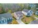 Aerial view featuring a two-story home with a lush lawn, landscaped garden beds, and a spacious driveway at 236 Emerald Isle Dr, Moncks Corner, SC 29461