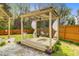 Backyard view of a relaxing hammock under a covered trellis with deck and white rock ground cover at 236 Emerald Isle Dr, Moncks Corner, SC 29461