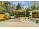 Backyard view of a covered grill and relaxing area with a white rock ground cover and deck at 236 Emerald Isle Dr, Moncks Corner, SC 29461