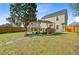 Backyard view of a covered grill, covered seating, and wooden fence surrounding the property at 236 Emerald Isle Dr, Moncks Corner, SC 29461