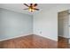 This bedroom features a ceiling fan, and access to a closet, all complemented by attractive wood-look flooring at 236 Emerald Isle Dr, Moncks Corner, SC 29461