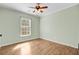 Bedroom featuring hardwood floors, a ceiling fan, and a window providing plenty of light at 236 Emerald Isle Dr, Moncks Corner, SC 29461