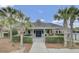 A charming clubhouse framed by palm trees offers a welcoming neighborhood gathering space at 236 Emerald Isle Dr, Moncks Corner, SC 29461