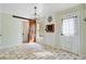 Bright dining area with decorative light fixture and sliding barn door leads to an adjacent space at 236 Emerald Isle Dr, Moncks Corner, SC 29461