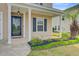 Cozy front porch area with a charming light fixture and view of the garden at 236 Emerald Isle Dr, Moncks Corner, SC 29461