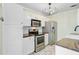 A well-equipped kitchen with white cabinets, stainless steel appliances, and modern lighting at 236 Emerald Isle Dr, Moncks Corner, SC 29461