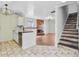 Kitchen showcases modern sink and connects seamlessly to the adjacent living area with fireplace and stairs at 236 Emerald Isle Dr, Moncks Corner, SC 29461