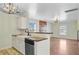 The kitchen features white cabinets, a large sink, and seamlessly connects to the adjacent living space at 236 Emerald Isle Dr, Moncks Corner, SC 29461