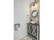 Stylish half-bathroom featuring modern fixtures, designer tile backsplash, and decorative mirror at 236 Emerald Isle Dr, Moncks Corner, SC 29461