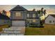 Charming two-story home with a manicured lawn and a two-car garage during a lovely sunset at 261 Celestial Blvd, Summerville, SC 29486