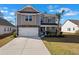 Beautiful two-story home with stone accents, a two-car garage, and a well-maintained front yard at 261 Celestial Blvd, Summerville, SC 29486