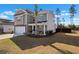 Lovely two-story home with a well-manicured lawn and a two-car garage on a beautiful day at 261 Celestial Blvd, Summerville, SC 29486