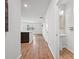 Bright hallway with wood floors leads to an open kitchen and bathroom with pedestal sink at 261 Celestial Blvd, Summerville, SC 29486