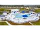 Aerial view of a modern community pool with umbrellas and lounge chairs, perfect for relaxation and recreation at 261 Celestial Blvd, Summerville, SC 29486