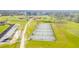 Aerial view of Cane Bay's pristine tennis courts featuring lush landscaping and a backdrop of community homes at 261 Celestial Blvd, Summerville, SC 29486