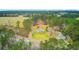 Aerial view of the property surrounded by lush greenery with detached buildings adding to its appeal at 276 S Railroad Ave, Harleyville, SC 29448