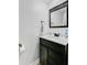 Modern bathroom vanity with a dark wood finish, white countertop, and stylish square mirror at 276 S Railroad Ave, Harleyville, SC 29448