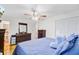 Comfortable bedroom featuring a ceiling fan, blue bedding and a dresser for storage at 276 S Railroad Ave, Harleyville, SC 29448