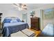 Bright bedroom with a ceiling fan, hard floors, and neutral decor and large dresser at 276 S Railroad Ave, Harleyville, SC 29448