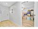 Hallway leads to a room filled with boxes, tile floor at the door, and a ceiling fan in the room at 276 S Railroad Ave, Harleyville, SC 29448