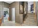 Hallway featuring stairs and access to laundry room, blending functionality with style in a well-maintained home at 276 S Railroad Ave, Harleyville, SC 29448