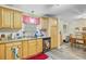 Functional kitchen with wood cabinets, granite countertops, and an adjacent dining area for casual meals at 276 S Railroad Ave, Harleyville, SC 29448