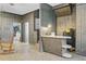 Living area with unique floor and wall textures, and a convenient bar area for entertaining at 276 S Railroad Ave, Harleyville, SC 29448