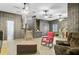 Bright living room boasts distinctive wall panels, unique flooring, and multiple ceiling fans at 276 S Railroad Ave, Harleyville, SC 29448