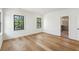 Bright bedroom boasts hardwood floors, black-trimmed windows, and an ensuite bathroom at 2950 Lodge Berry Ln, Johns Island, SC 29455
