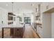 Spacious kitchen island with marble countertops, wooden cabinets, and a view of the living area at 2950 Lodge Berry Ln, Johns Island, SC 29455
