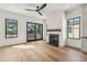 Bright living room with hardwood floors, a fireplace, large windows, and a ceiling fan at 2950 Lodge Berry Ln, Johns Island, SC 29455