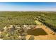 Majestic aerial view capturing a large property with a lake, scattered trees, and residences at 2964 Lodge Berry Ln, Johns Island, SC 29455