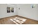 Sun-filled bedroom with hardwood floors, neutral paint, and windows at 2964 Lodge Berry Ln, Johns Island, SC 29455