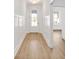 Bright entryway featuring wood floors, board and batten wainscoting, and a modern front door at 2964 Lodge Berry Ln, Johns Island, SC 29455