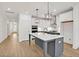 Open kitchen with a gray island, white cabinets, stainless steel appliances, and tile backsplash at 2964 Lodge Berry Ln, Johns Island, SC 29455