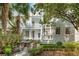 Inviting backyard with patio, lush landscaping, and a charming two-story home with a rooftop deck at 3 Atlantic St, Charleston, SC 29401