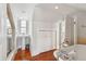 Bright bathroom with a vintage pedestal sink, soaking tub with chrome fixtures, and a window with shutters at 3 Atlantic St, Charleston, SC 29401