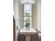 Bright bathroom boasts a pedestal sink, large window, and modern fixtures at 3 Atlantic St, Charleston, SC 29401