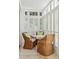 Bright breakfast nook with a round table, wicker chairs, and window shutters at 3 Atlantic St, Charleston, SC 29401