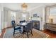 Elegant dining room with decorative chandelier, fireplace, and seating for five at 3 Atlantic St, Charleston, SC 29401