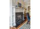 Charming fireplace with decorative screen, brick surround, and a classic white mantel displaying blue vases and artwork at 3 Atlantic St, Charleston, SC 29401