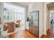 Bright, updated kitchen with stainless steel appliances, hardwood floors, and a large refrigerator with a breakfast nook beyond at 3 Atlantic St, Charleston, SC 29401