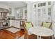 Bright, updated kitchen featuring stainless steel appliances, hardwood floors, and a breakfast nook with sun-drenched shutters at 3 Atlantic St, Charleston, SC 29401