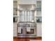 Stainless steel range with oven and hood, complemented by white cabinets and granite countertops in a well-equipped kitchen at 3 Atlantic St, Charleston, SC 29401