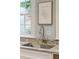 Close up on a stainless steel kitchen sink with granite countertops and an elegant chrome faucet, framed by a sunny window at 3 Atlantic St, Charleston, SC 29401