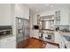 Spacious kitchen with stainless steel refrigerator and range, white cabinetry, granite countertops, and hardwood floors at 3 Atlantic St, Charleston, SC 29401