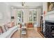 Bright living room with large fireplace, neutral decor, and beautiful French doors at 3 Atlantic St, Charleston, SC 29401