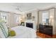 Bright main bedroom with fireplace, ensuite, and windows with white curtains at 3 Atlantic St, Charleston, SC 29401